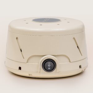 Front view of Dohm Classic tan white noise machine showcasing front power dial and angled air vents on a beige background