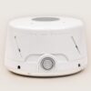 Three-quarter front view of Dohm Classic fan-based white noise machine showcasing side vents and central power dial on a light background
