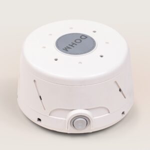 Three-quarter front view of Dohm Classic white sound machine showing top vents and power button on light background