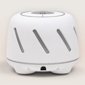 Front view of Dohm Connect white noise machine showing diagonal vent slots and top control dial on a light beige background