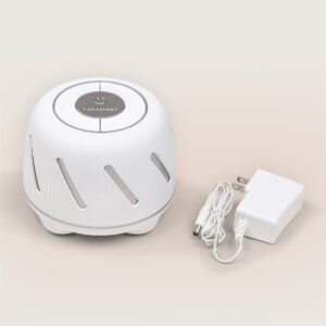 Front view of Dohm Connect featuring diagonal vents and top control dial with power adapter on beige background