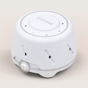 Angled top view of Dohm sound machine showcasing ribbed white housing, visible DOHM logo, and front power dial on a neutral beige background