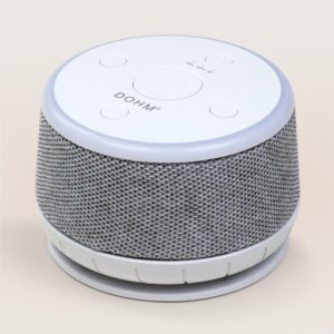 Three-quarter view of Dohm Nova showing gray fabric wrap, white top controls and soft night-light ring on neutral background