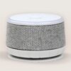 Front angled view of Dohm Nova sound machine showcasing gray knit fabric speaker wrap and white top control panel on pale beige background