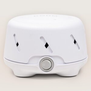 Front view of Dohm Uno white noise machine showcasing single dial power switch and ventilation slots on neutral background