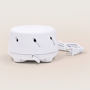 Front low-angle view of Dohm Uno white noise machine showing cord wrap and ventilation slots on beige background