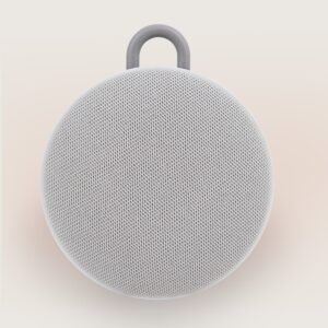 Front view of Hushh 2 portable sound machine showing round fabric speaker grille and gray carrying loop on light background