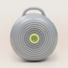 Front view of Hushh portable sound machine with circular speaker grille, top handle, and yellow accent buttons