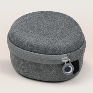 Front view of medium travel case in linen showcasing zip closure and fabric texture on beige background