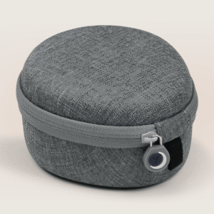 Three-quarter view of medium travel case showcasing zippered closure, textured linen fabric, and round zipper pull on a light neutral background